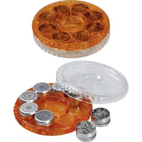 Pyöreä, läpinäkyvä/oranssi annostelukapselilipas, joka sisältää kahdeksan tyhjää nestekapselia.